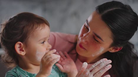 joyful moments of playful interaction between a mother and her child covered in flour, celebrating the simple pleasures of family togetherness and fun