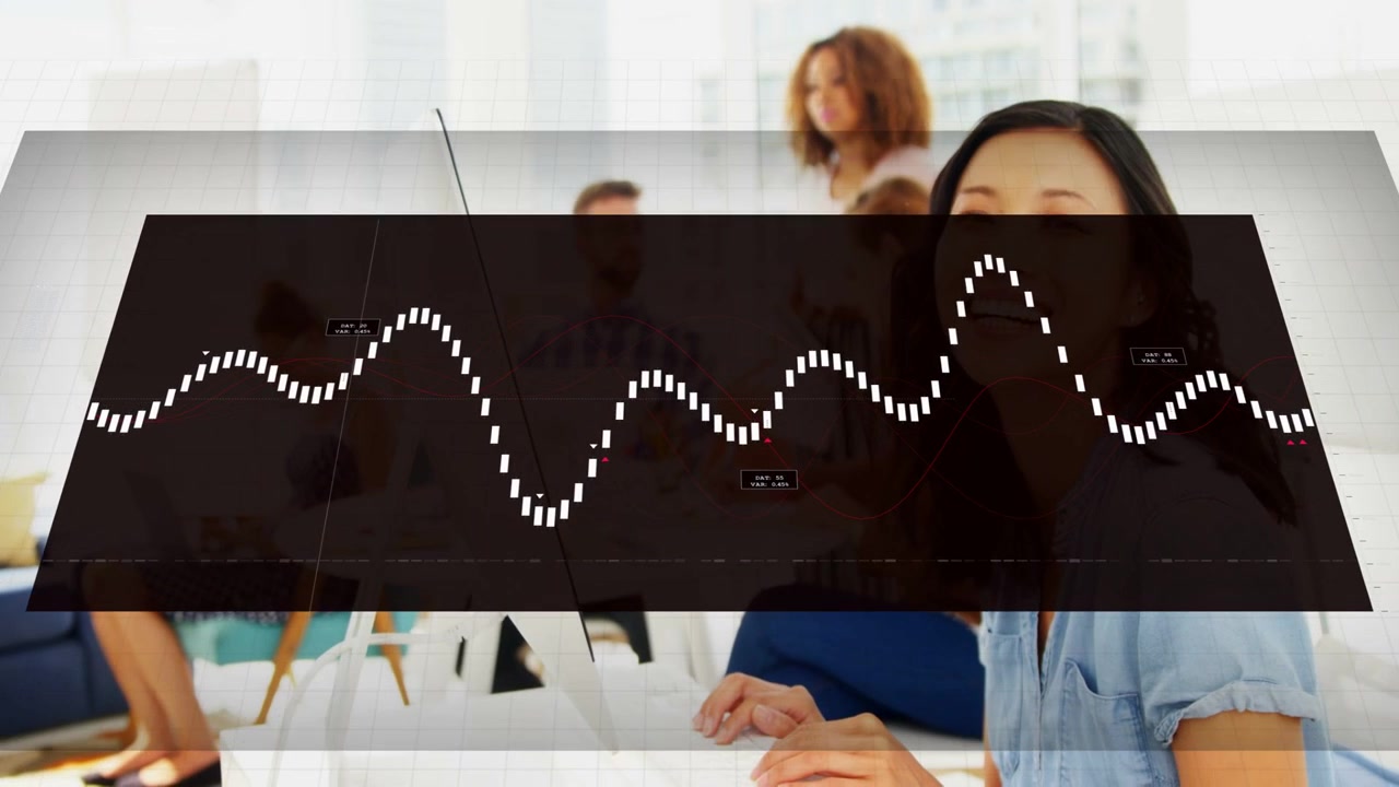 Woman at desk typing while system starting overlay and rising waveform, obscuring team for business