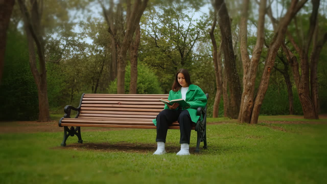 Woman Reading a Book on a Park Bench