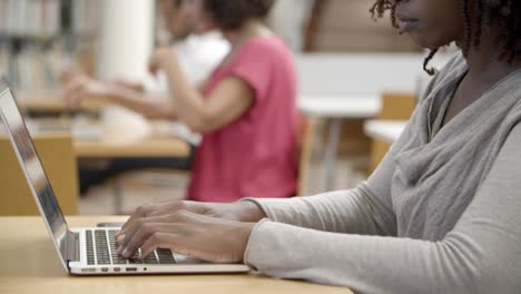 side view of concentrated student working with laptop