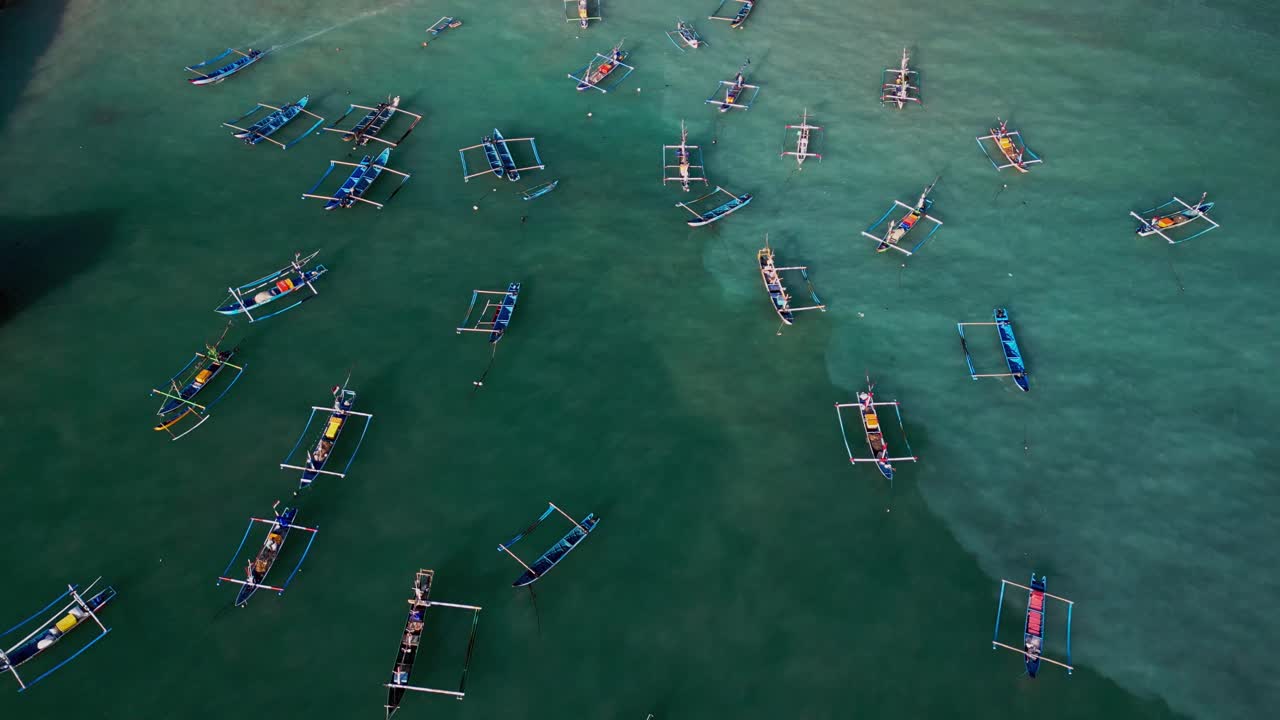 Tropical Bali harbor with wooden outriggers clustered in clear turquoise sea, emphasizing traditional fishing culture, local heritage, and the beauty of Indonesia’s maritime scenery