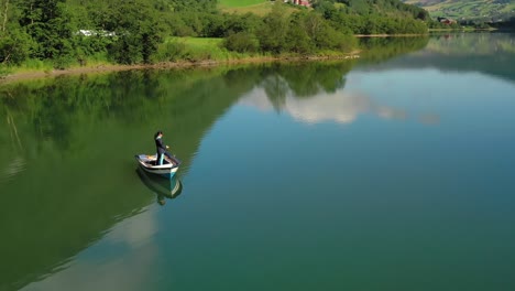 Woman-on-the-boat-catches-a-fish-on-spinning-in-Norway.