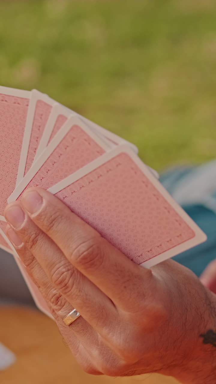 Friends Playing Cards at a Picnic
