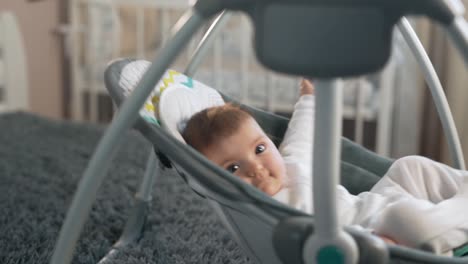 close-up of a cute baby girl swinging in a swing