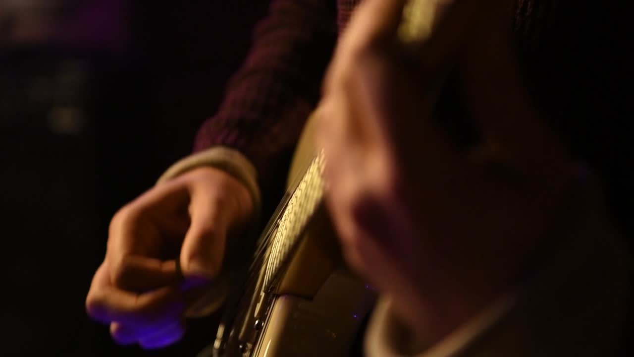 Strumming a guitar chord in slow motion