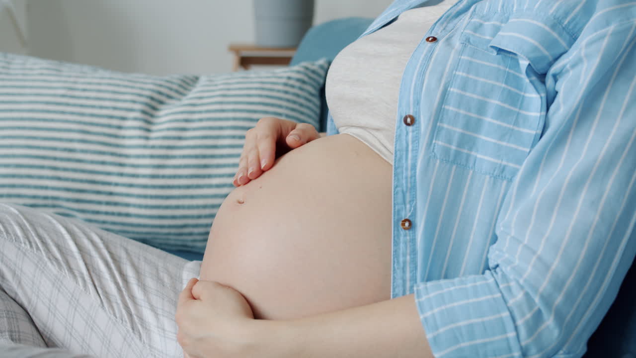 임신 한 여자는 그녀의 아랫 배를 만지고