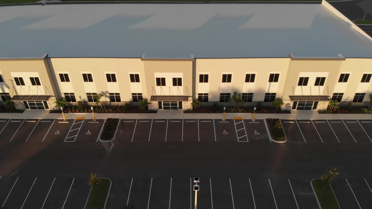Aerial of newly constructed modern offices, light industrial, business facilities designed with white roofing