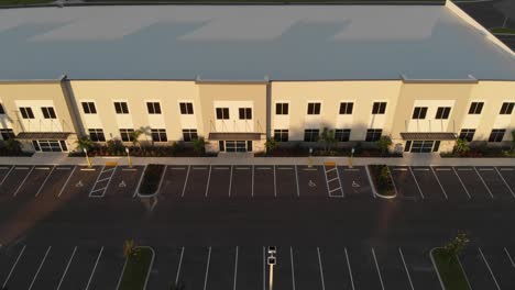 Aerial-of-newly-constructed-modern-offices,-light-industrial,-business-facilities-designed-with-white-roofing
