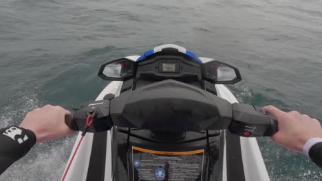 POV-shot-of-a-jet-skier-racing-across-the-ocean-splashing-and-surfing-waves