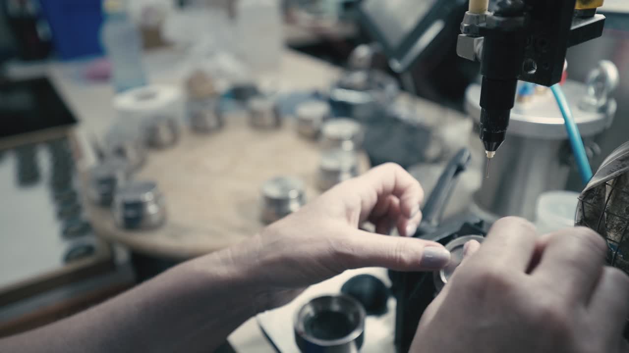 Close-up of precision machinery assembling speakers in a modern factory, detailed manufacturing process, industrial technology