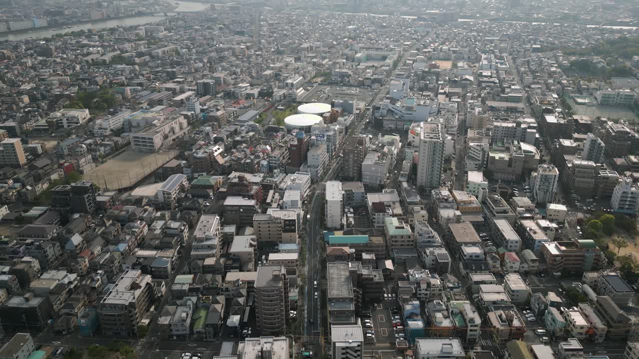 Aerial Scenic Urban Drone Footage of a neighborhood, streets and buildings in the Capital City of Tokyo, Japan during Sunset