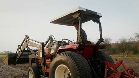 farmer driving a tractor in a field