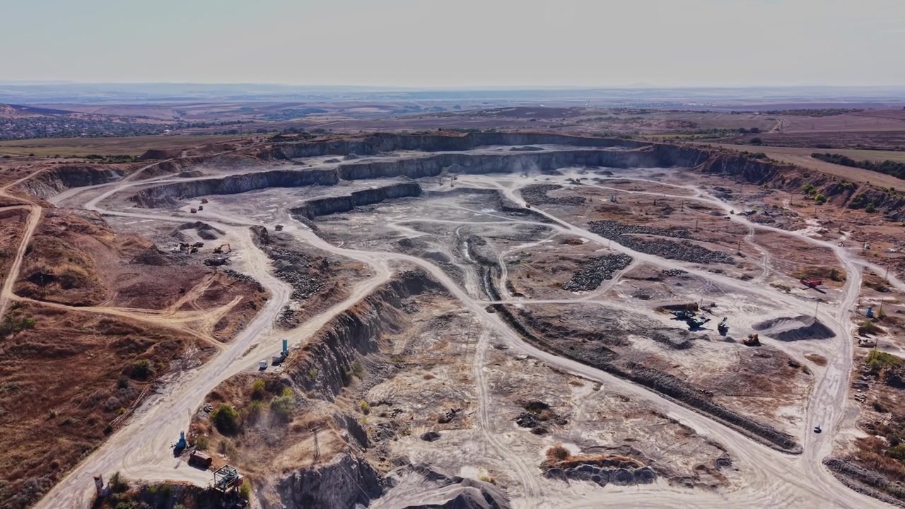 Construction site in an open pit mine near a rural area