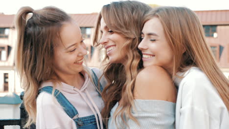 three happy women hugging and laughing