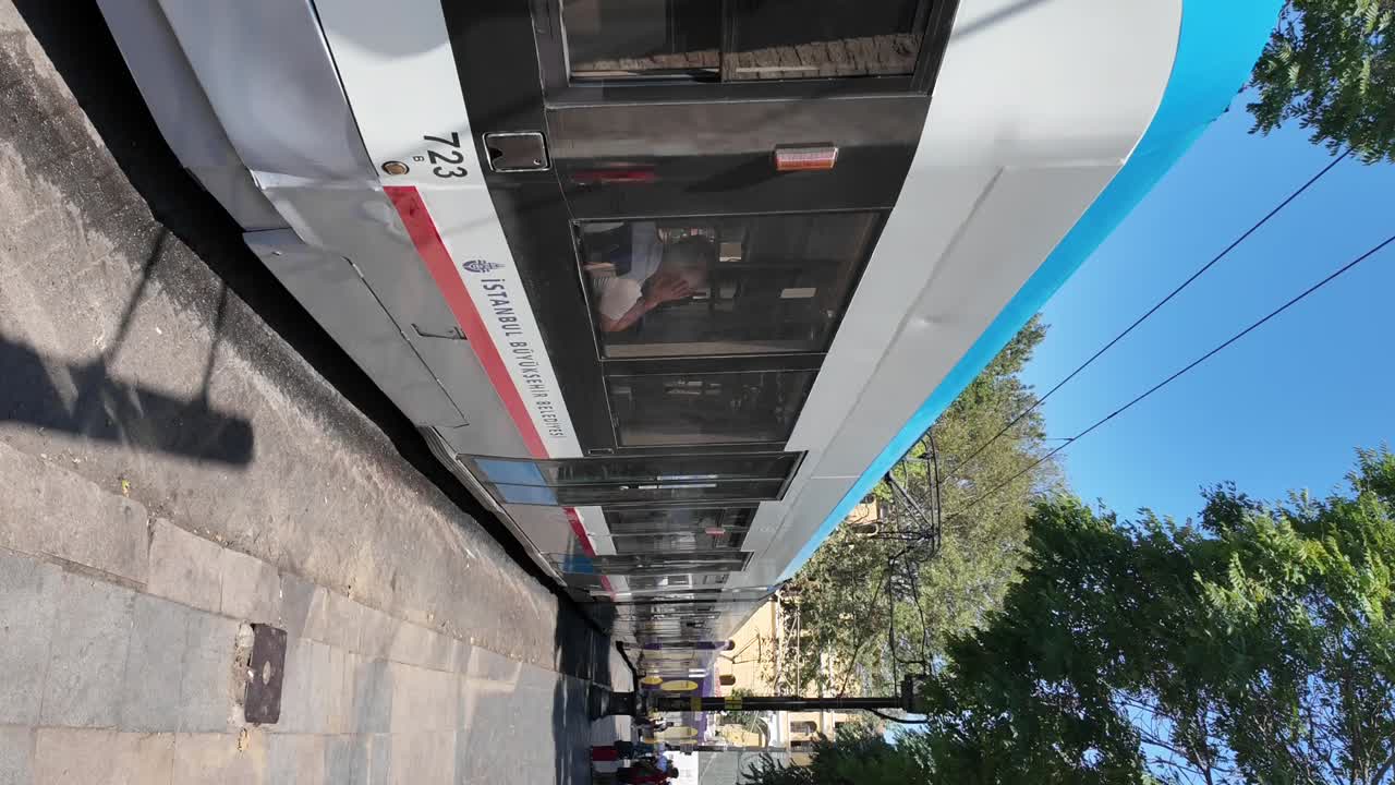 Modern Tram Stopped at an Urban Station on a Sunny Day