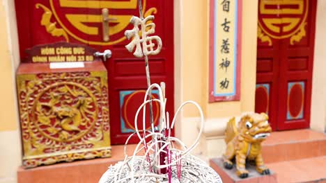 incense burner in front of temple entrance