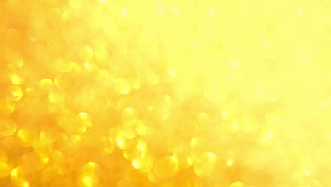 decorative defocused abstract gold background with sparkling glitter. festive and holiday background for text. 4k footage