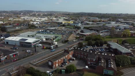 aerial drone panning across rural village houses and supermarket, essex england