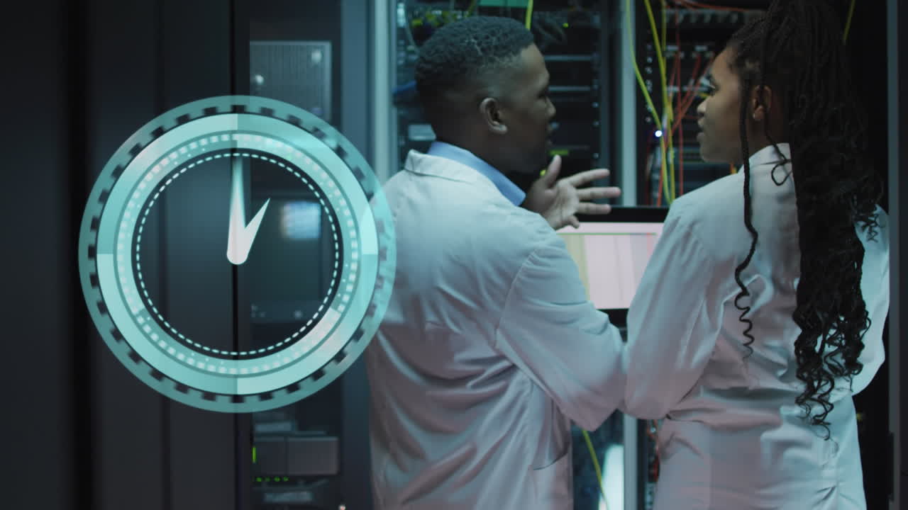 Animation of clock moving over african american man and woman working in servers room
