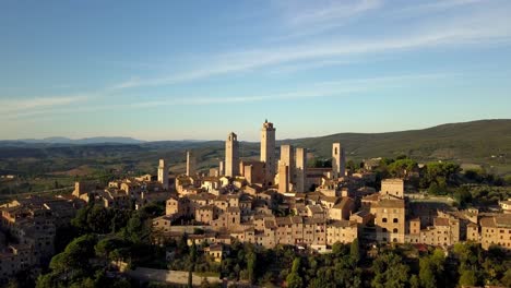 san gimignano town in tuscany italy panorama of the tower structures including torre grossa, aerial drone orbit reveal shot