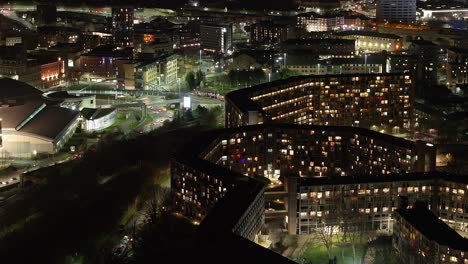 Urban residential buildings at night in Sheffield, UK, sinking aerial
