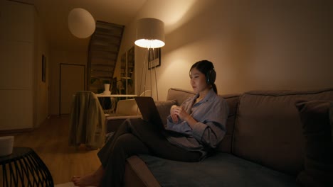 woman working on laptop at night at home