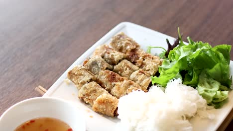 bun cha dish with herbs and dipping sauce