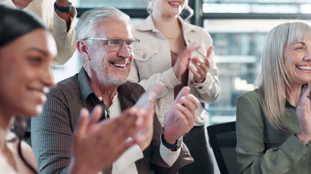 Group of diverse business people clapping at a meeting