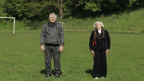 Active-senior-old-couple.-Man-and-woman-do-stretching-physical-exercises