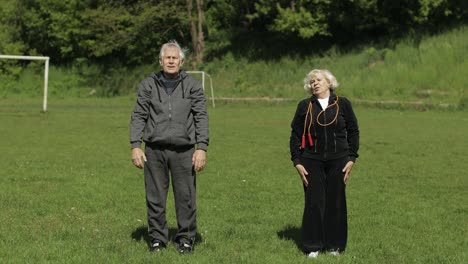 active senior old couple. man and woman do stretching physical exercises