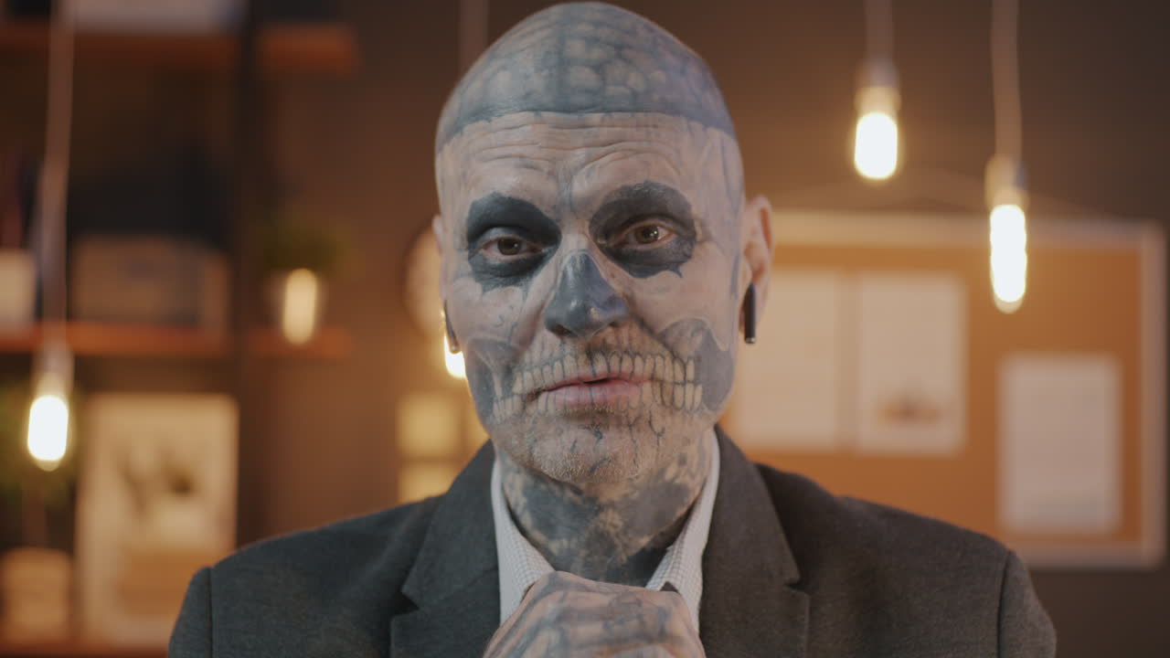 Man with Skull Tattoo and Makeup in Business Suit