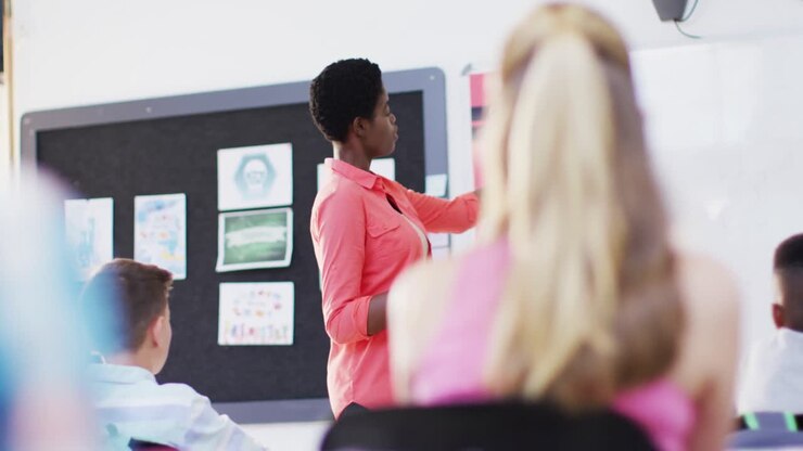 African american female teacher with diverse schoolchildren at classroom, slow motion