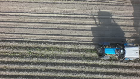 Potato-harvesting-machine-on-the-farmland-aerial