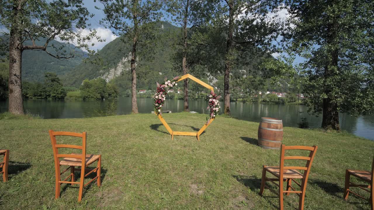호수 의자와 잔디 돌리의 육각형 아치로 야외 결혼식 설정
