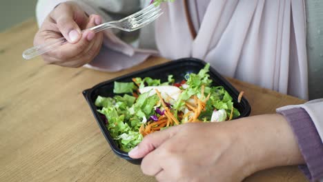 woman eating salad