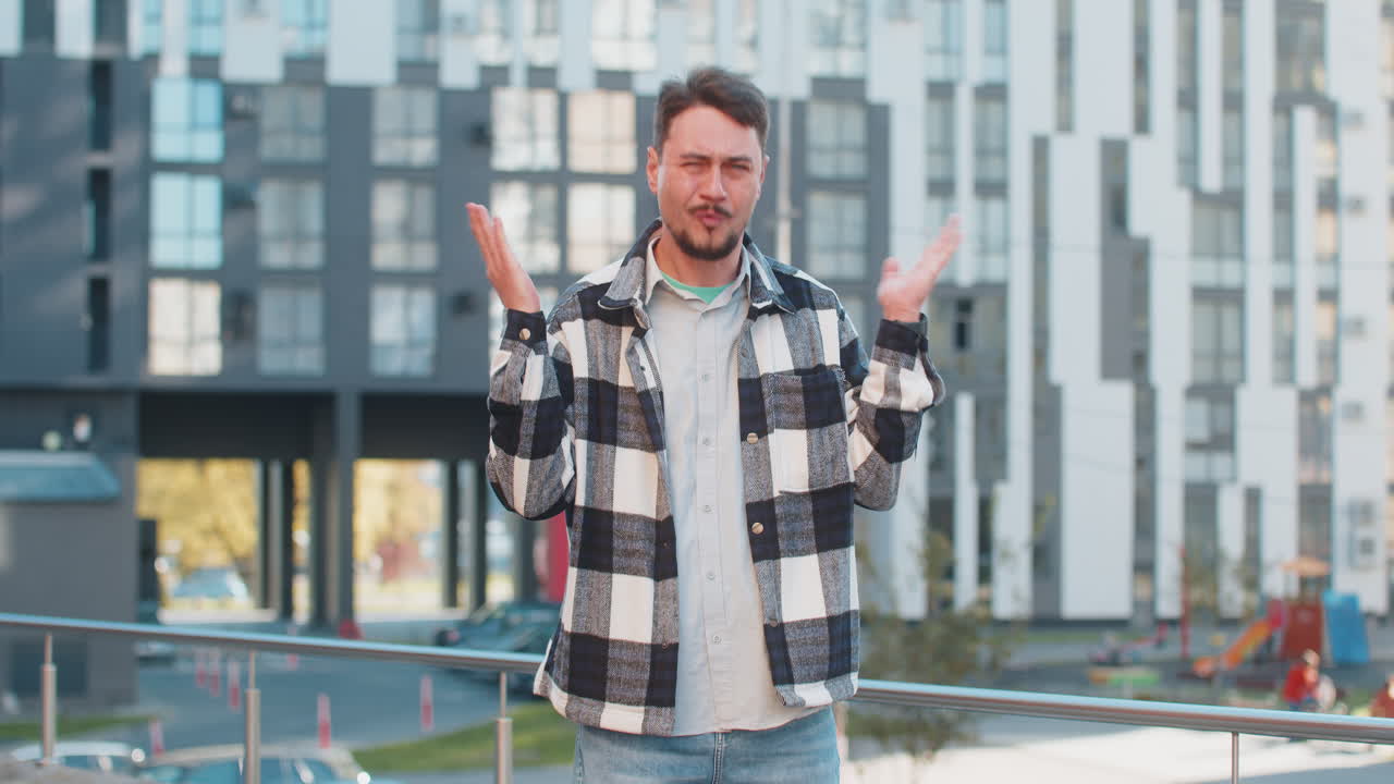 Doubtful sad frustrated mature caucasian man shrugging shoulders dont know answer on city street