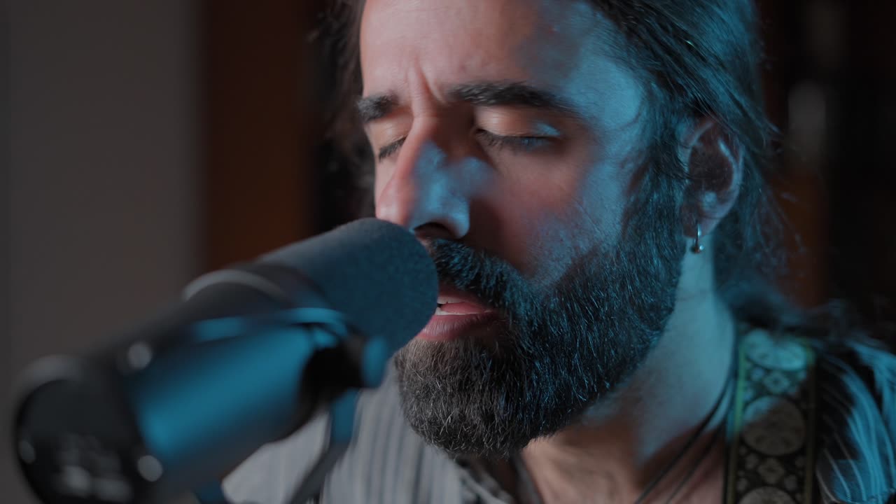 Close up of a man singing into a microphone