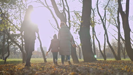 Family walking in the park during autumn