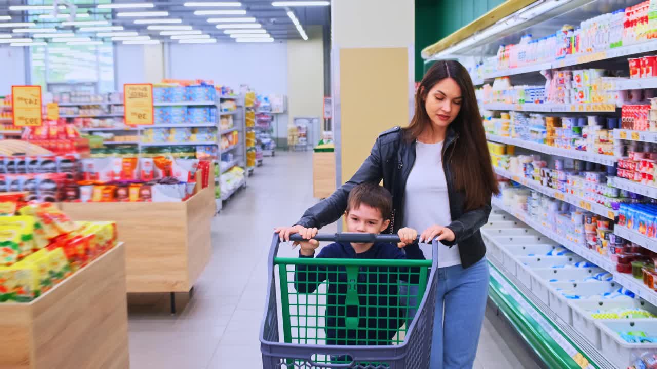 A Mother and Son Enjoy a Shopping Trip Together at a Grocery Store, Exploring Various Aisles Filled with Colorful Products and Fresh Produce