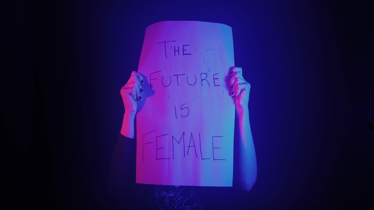 Person Holding 'The Future Is Female' Sign Under Neon Lights