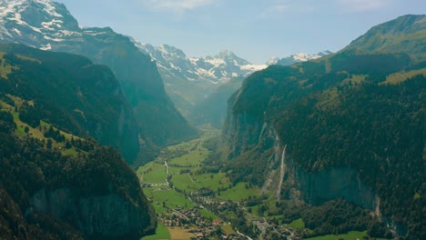 summer in swiss valley between scenic alps mountains, aerial panorama