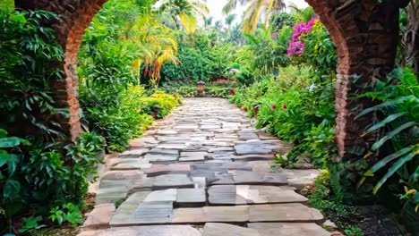 a wooden table in the middle of a lush green garden