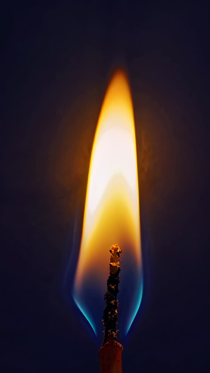 Close-up video concept of a candle flame against a dark background