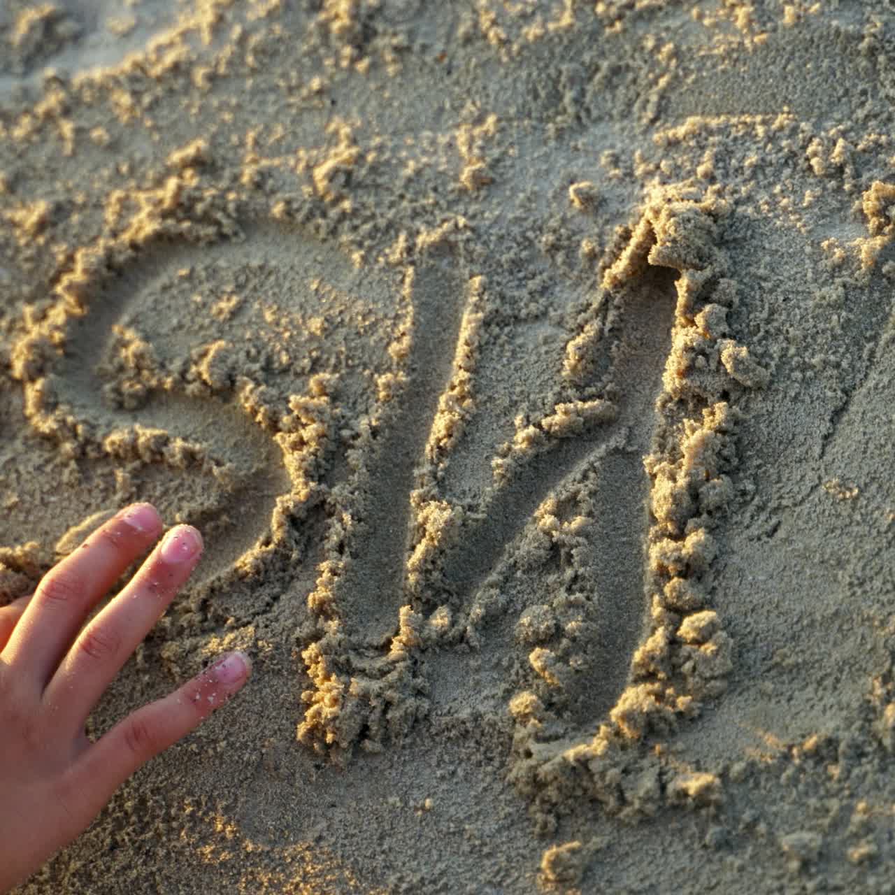 Inscription of handwritten on sand