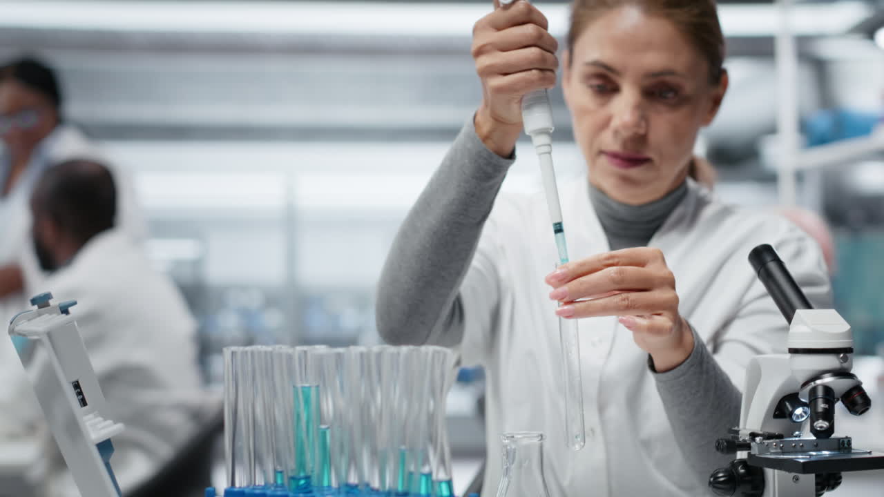 Molecular biologist pipetting reactant into blue solution for purity analysis