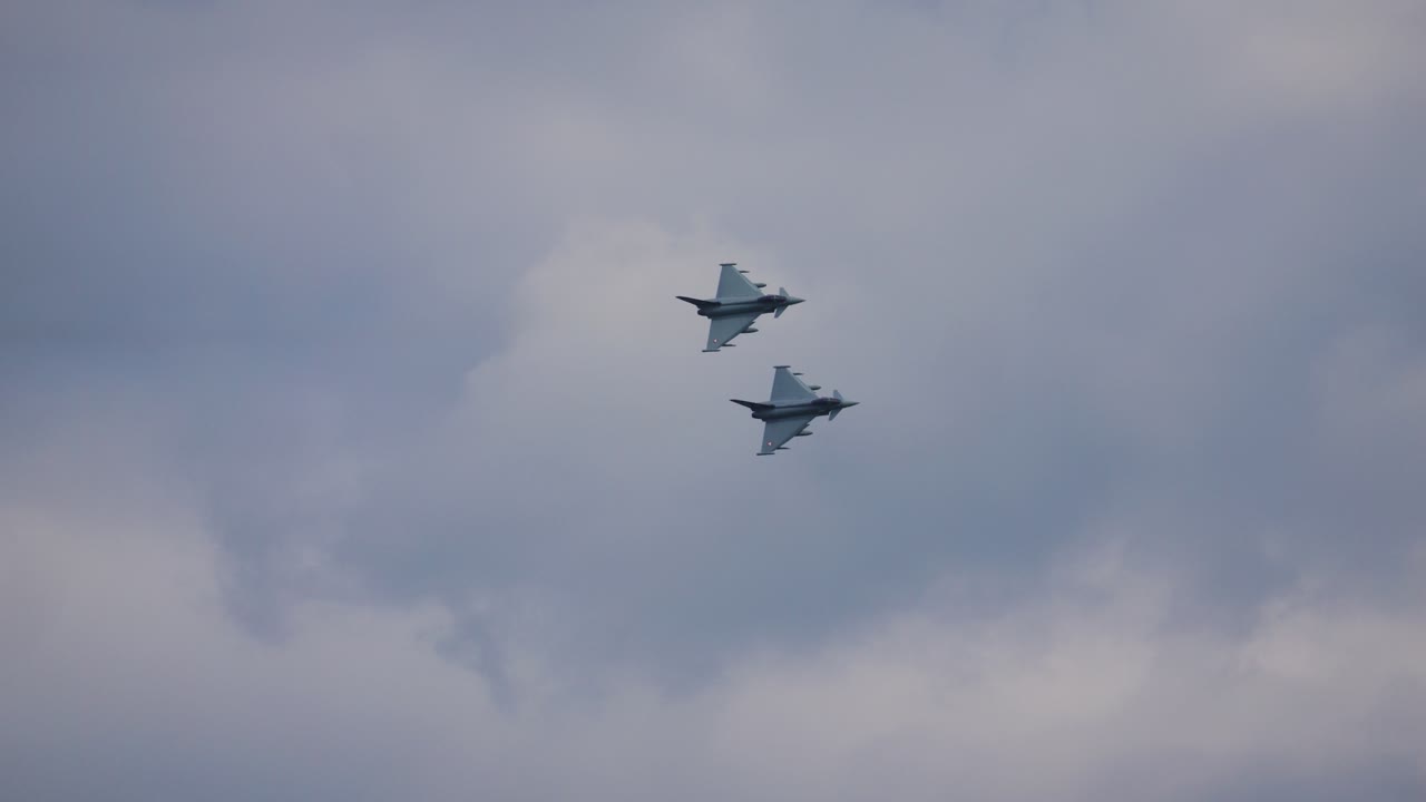 Two eurofighter military combat aircraft fly in a beautiful formation close to each other through the air at Aipower 2024