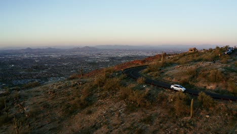 Drone shot of a car driving down a mountain in Phoenix, Arizona