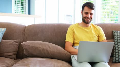 Man-using-laptop-in-living-room