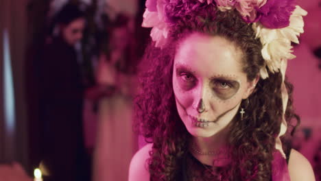 woman showing her teeth at camera at a halloween party