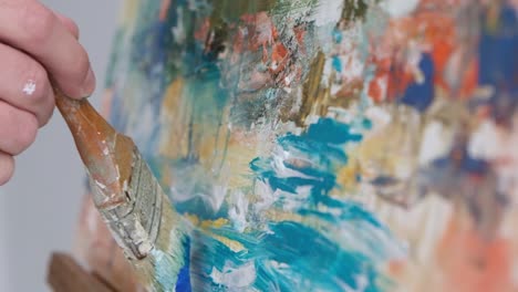 a contemporary artist who creates abstract works of art in the art nouveau style - close up of oil painting. a contemporary artist who creates abstract works of art in the art nouveau style. super slow motion